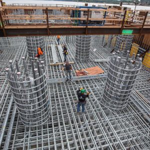 Ironworkers arrange layer upon layer of steel reinforcements in the new bridge's foundations.